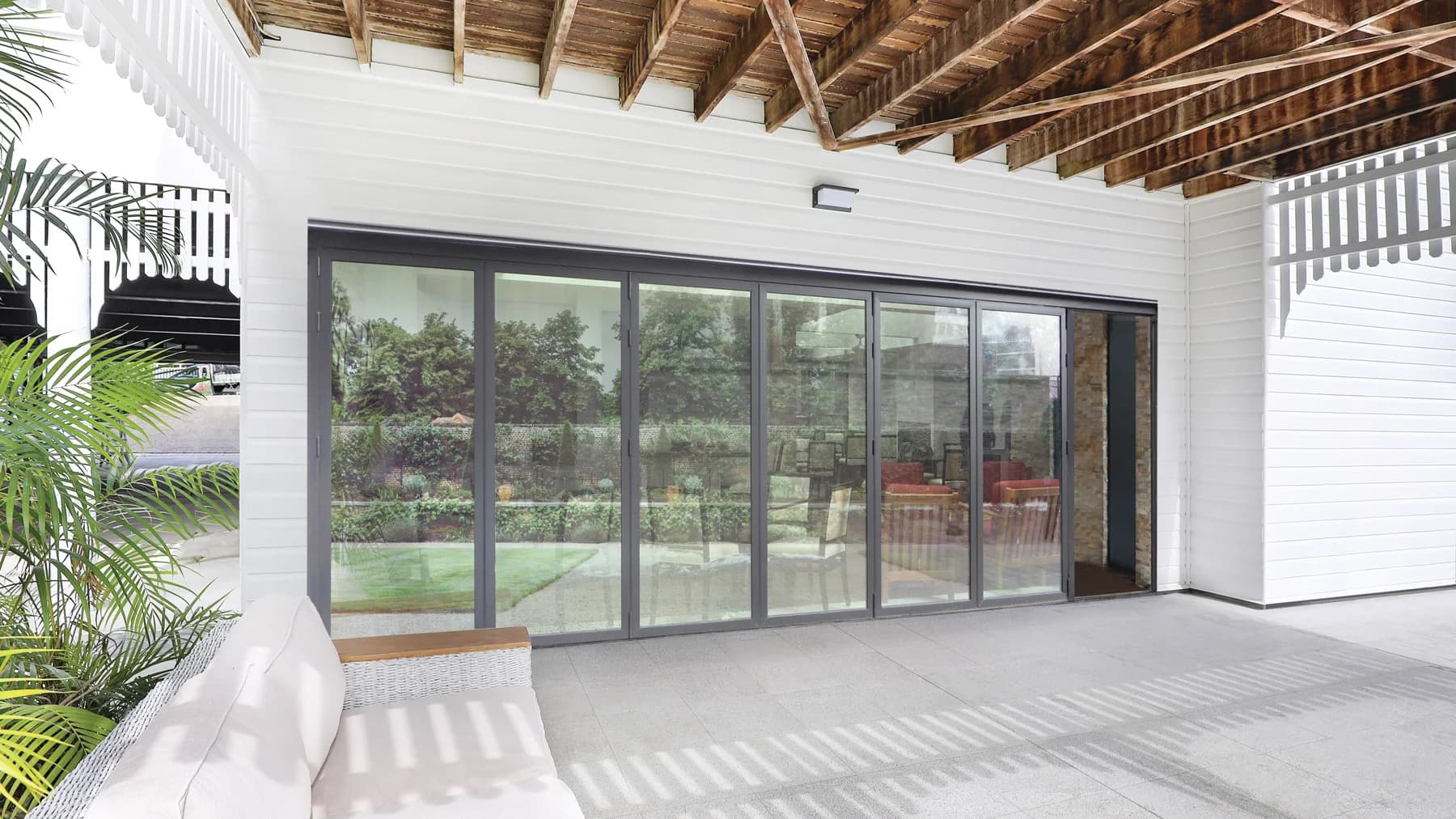 Aluminum folding doors across a wide covered porch
