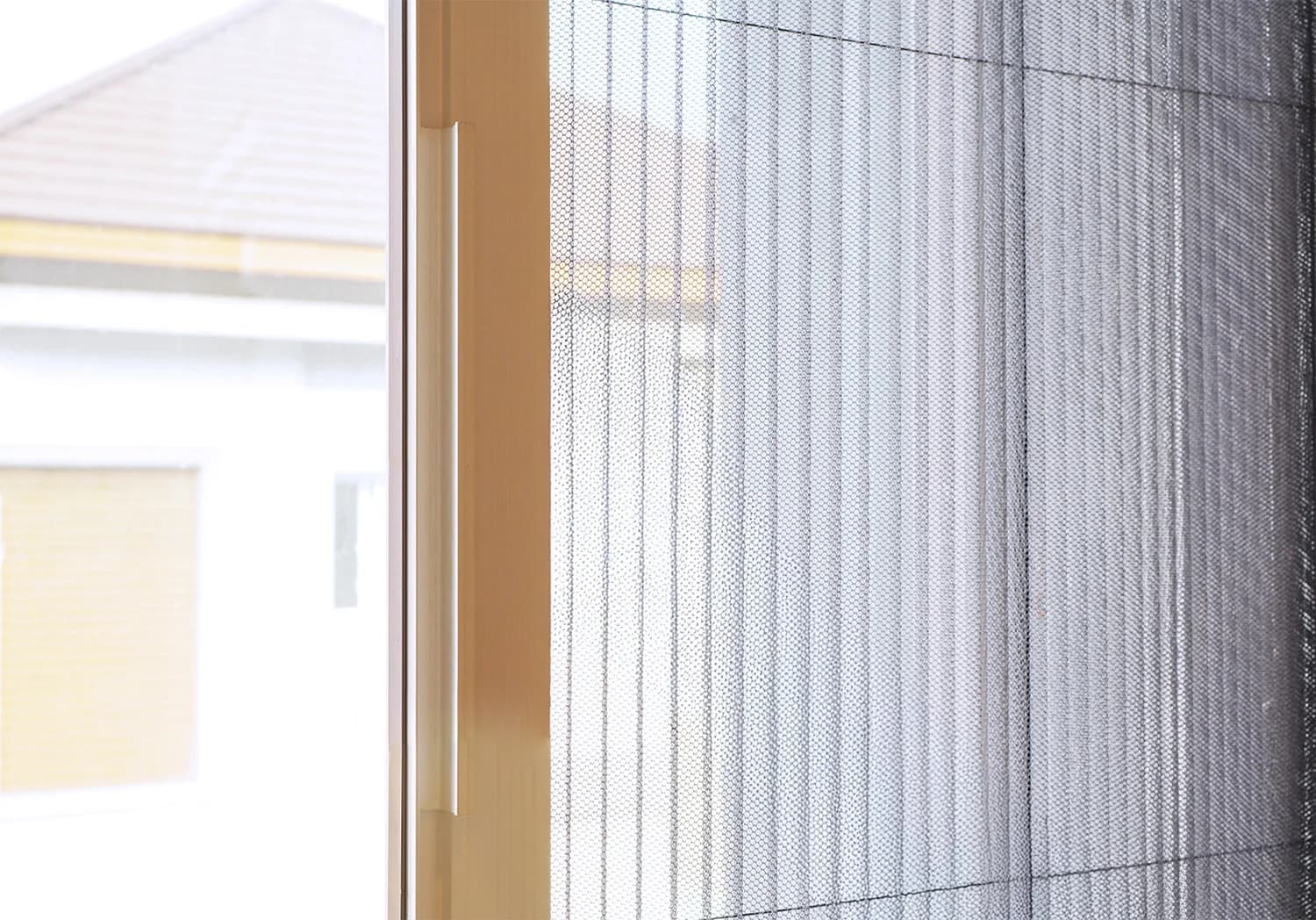 Pleated retractable screen across a folding opening