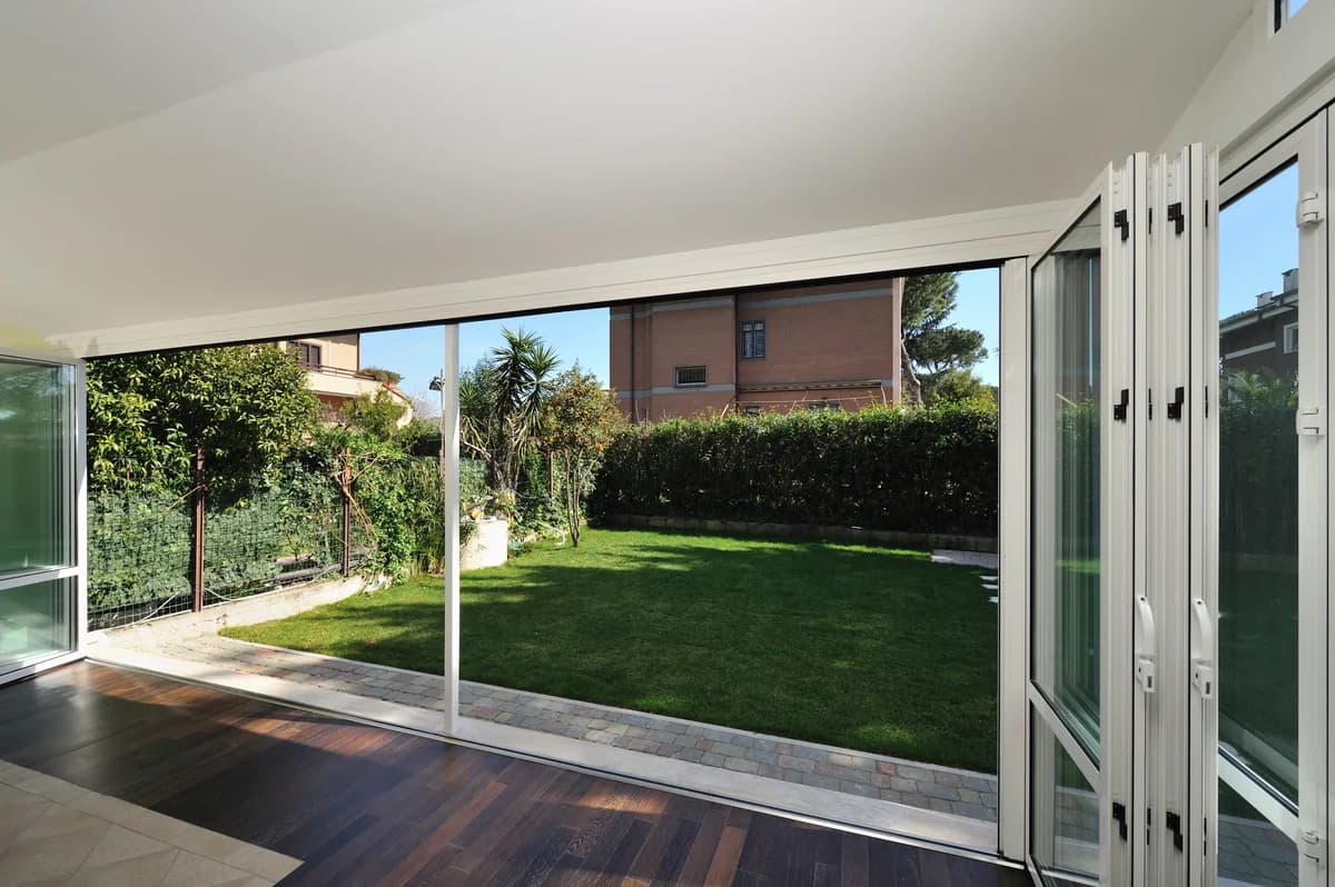Wide folding door opening onto a garden