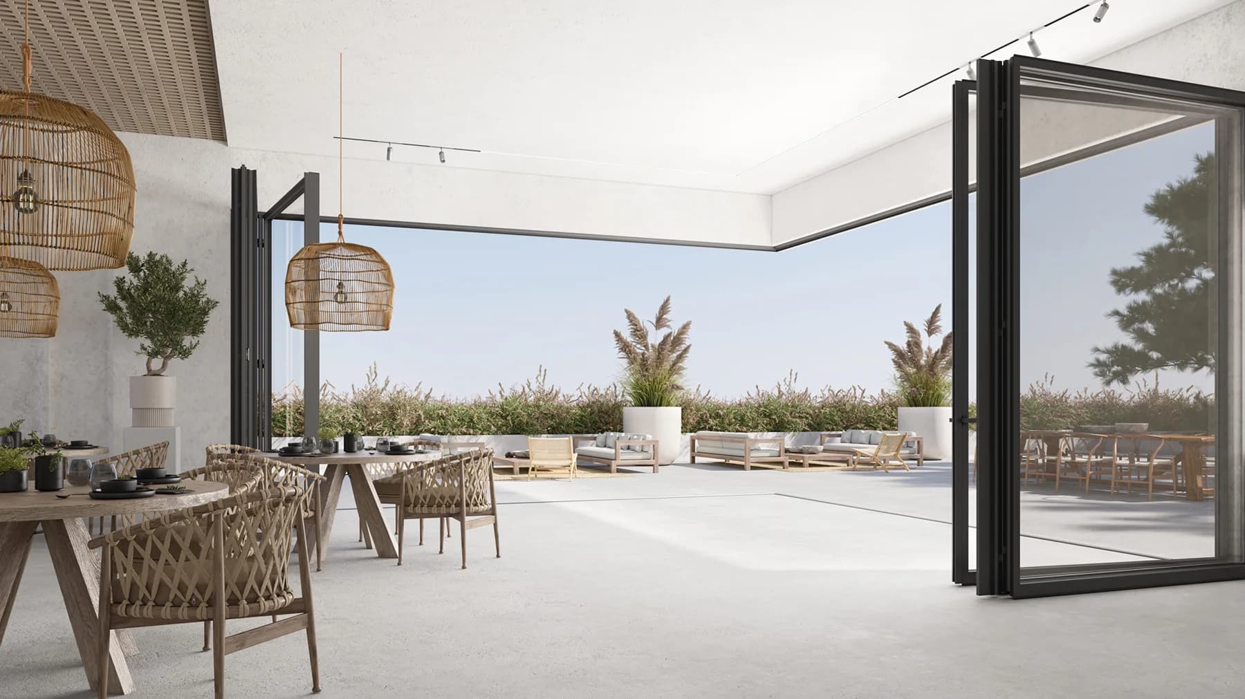 Folding glass doors open between a dining room and a covered terrace